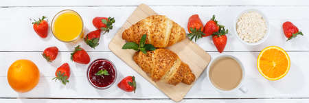 Croissant breakfast croissants orange juice coffee food wooden board from above banner top viewの写真素材