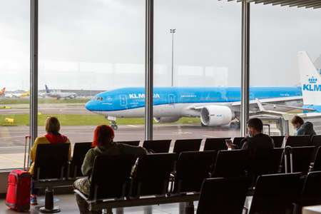 Amsterdam, Netherlands - May 21, 2021: Passengers with KLM Royal Dutch Airlines airplane at Amsterdam Schiphol airport (AMS) in the Netherlands.のeditorial素材