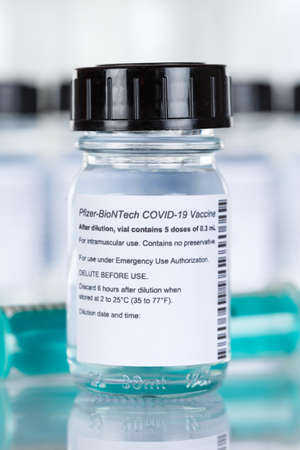 Stuttgart, Germany - March 19, 2021: Biontech Pfizer Coronavirus Vaccine Corona Virus COVID-19 Covid syringe vaccines portrait format in Germany.のeditorial素材