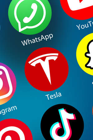Stuttgart, Germany - April 5, 2021: Tesla company App logo icon on the internet background portrait format in Stuttgart, Germany.のeditorial素材