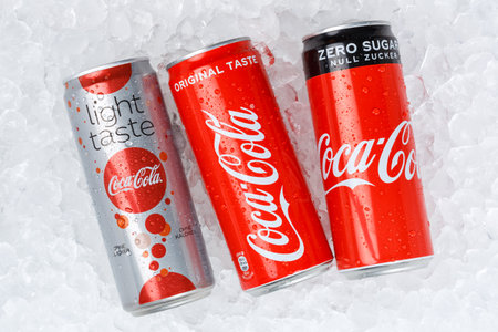 Stuttgart, Germany - January 17, 2021: Coca Cola Coca-Cola products lemonade soft drinks in cans on ice cubes in Stuttgart, Germany.のeditorial素材