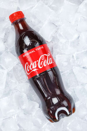 Stuttgart, Germany - August 31, 2021: Coca Cola Coca-Cola in plastic bottle lemonade soft drink on ice cubes portrait format in Stuttgart, Germany.のeditorial素材