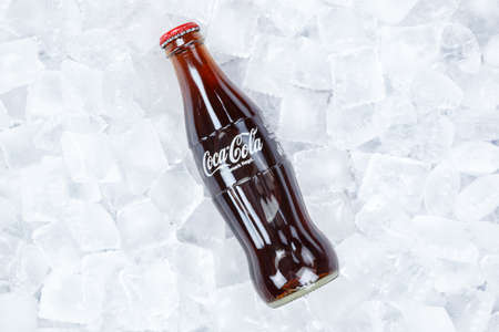 Stuttgart, Germany - August 31, 2021: Coca Cola Coca-Cola bottle lemonade soft drink on ice cubes in Stuttgart, Germany.のeditorial素材