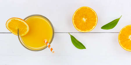 Orange juice drink on wooden board from above panorama orangesの写真素材