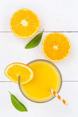 Orange juice drink on wooden board from above portrait format orangesの写真素材