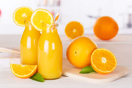 Orange juice drink in bottle on wooden board orangesの写真素材