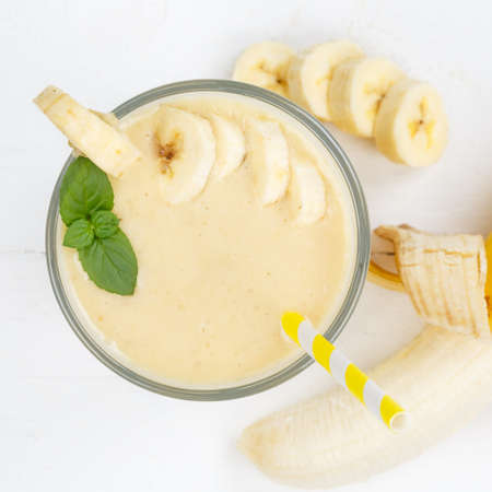 Banana fruit juice smoothie fresh drink in a glass from above square healthy drinkingの写真素材