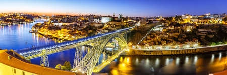 Porto Portugal with bridge Ponte Dom Luis I Douro river town travel panorama at twilight nightの写真素材