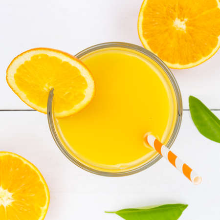 Orange juice drink on wooden board from above square orangesの写真素材