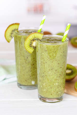 Green smoothie fruit juice kiwi drink in a glass portrait format healthy drinkingの写真素材