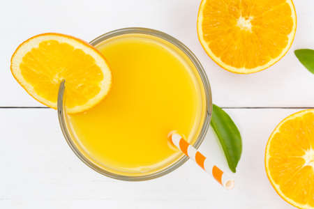 Orange juice drink on wooden board from above orangesの写真素材