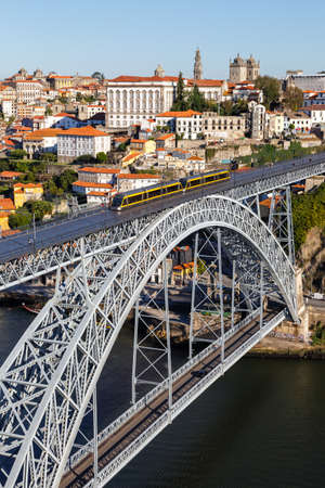 Porto Portugal with bridge Ponte Dom Luis I Douro river with tram town travel portrait format travelingの写真素材