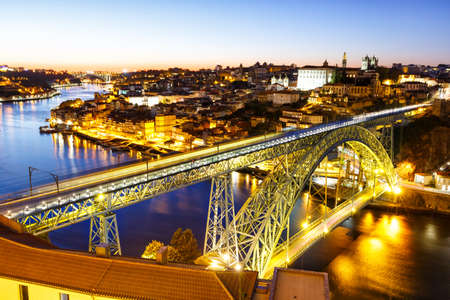 Porto Portugal with bridge Ponte Dom Luis I Douro river town travel at twilight nightの写真素材