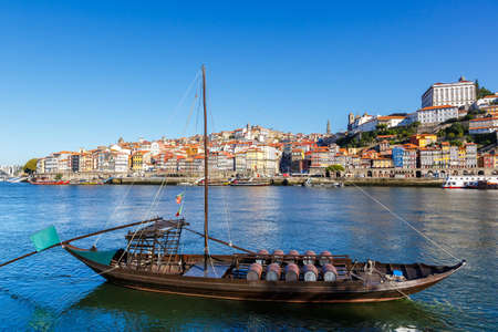 Porto Portugal old town buildings with boat ship on Douro riverの写真素材
