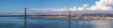 Lisbon Portugal bridge Ponte 25 de Abril over Tejo river panorama town travel travelingの写真素材