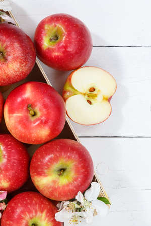 Apples fruits red apple fruit with leaves from above with copyspace copy space on a wooden board portrait format top viewの写真素材