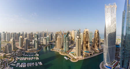 Dubai Marina and Harbor skyline architecture overview wealth luxury travel in United Arab Emirates with boats yacht panorama modernの写真素材