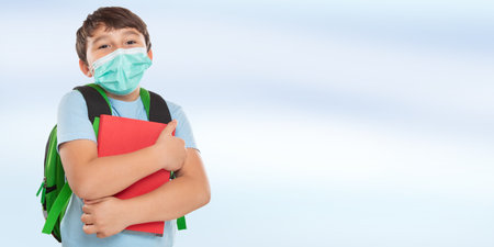 Young student child kid little boy wearing face mask against Viruswith copyspace copy space bannerの写真素材