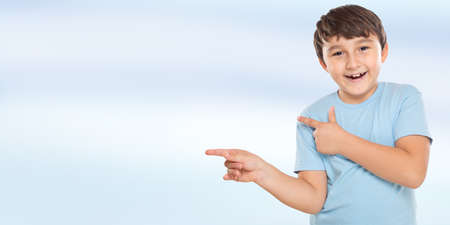 Child kid little boy showing with finger pointing on ad advertising with copyspaceの写真素材