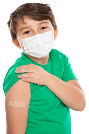 Child kid with plaster after virus vaccination wearing face mask against Virus isolated on white portrait formatの写真素材