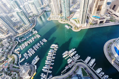 Dubai Marina and Harbor luxury wealth travel with boats yacht in United Arab Emirates from above richの写真素材