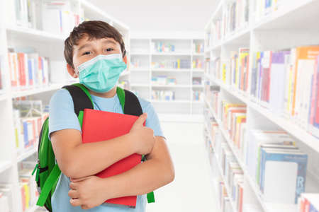 Young student child kid little boy at school wearing face mask against virus with copyspace copy space pupilの写真素材