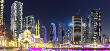 Mosque at Dubai Marina skyline architecture wealth luxury travel at night panorama in United Arab Emirates Islamの写真素材