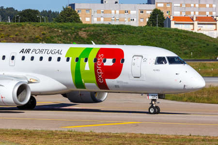 Porto, Portugal - September 21, 2021: TAP Portugal Express Embraer 190 airplane at Porto airport (OPO) in Portugal.のeditorial素材