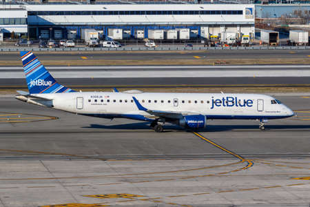 New York, United States - March 1, 2020: JetBlue Embraer 190 airplane at New York JFK airport in the United States.のeditorial素材