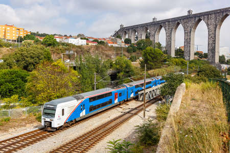 Lisbon, Portugal - September 24, 2021: Fertagus rail railway train at aqueduct Aqueduto das Aguas Livres in Lisbon Lisboa, Portugal.のeditorial素材