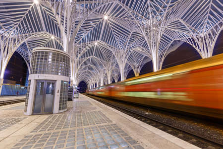 Lisbon, Portugal - September 23, 2021: Train at Lisbon Lisboa Oriente railway station modern architecture at night in Portugal.のeditorial素材