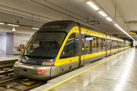 Porto, Portugal - September 21, 2021: Modern light rail Metro do Porto tram public transport transit transportation traffic at Trindade station in Porto, Portugal.のeditorial素材