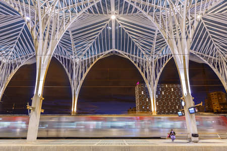 Lisbon, Portugal - September 23, 2021: Train at Lisbon Lisboa Oriente railway station modern architecture at night in Portugal.のeditorial素材