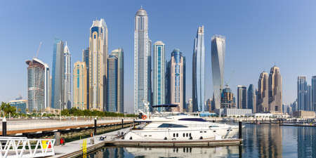 Dubai Marina and Harbor skyline architecture wealth luxury travel in United Arab Emirates with boat yacht panorama modernのeditorial素材
