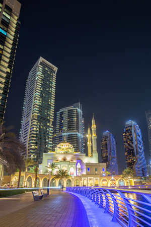 Mosque at Dubai Marina skyline architecture wealth luxury travel at night portrait format in United Arab Emirates Islamのeditorial素材