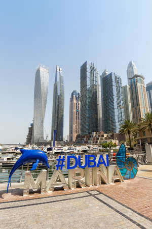 Dubai Marina logo and Harbor skyline architecture wealth luxury travel portrait format in United Arab Emirates cityのeditorial素材