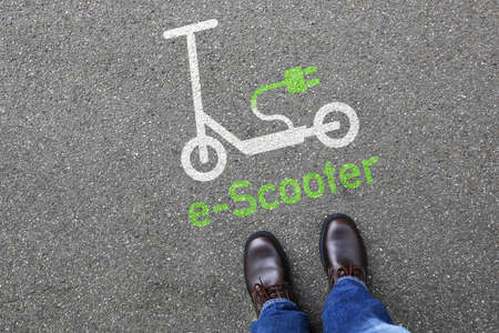 Man people electric scooter e-scooter road sign eco friendly green mobility city transport transportationの写真素材