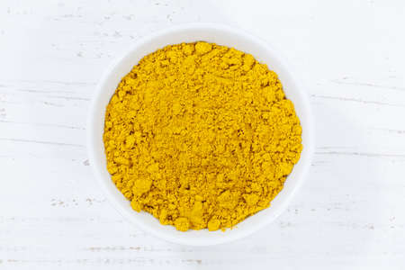 Curry powder spice from above bowl wooden board woodの写真素材