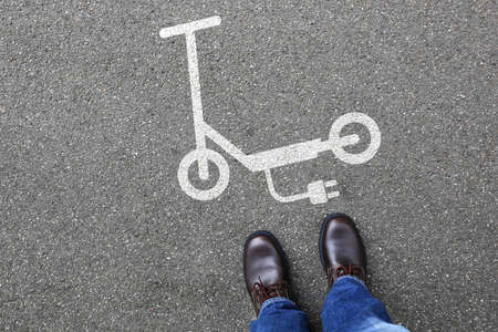 Man people electric scooter e-scooter road sign eco friendly mobility city transport transportationの写真素材