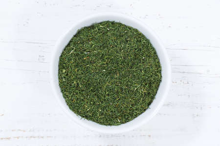 Dill herb from above bowl wooden board woodの写真素材