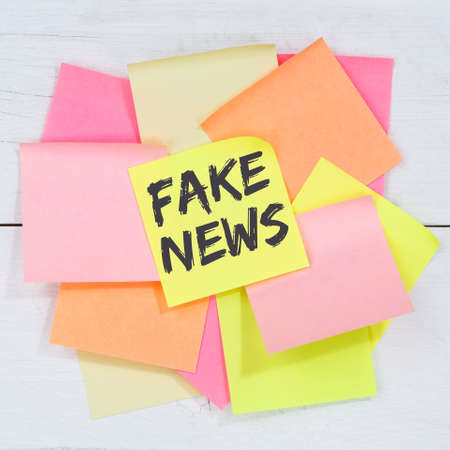 Fake news truth lie media internet online business concept desk note paper notepaperの写真素材