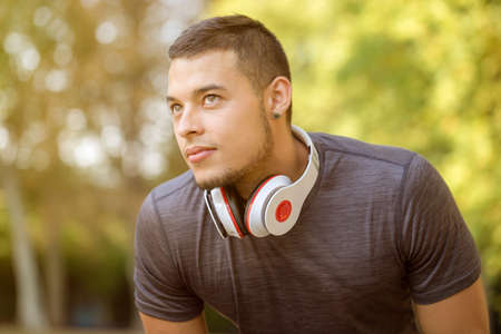 Young latin man runner looking up thinking copyspace copy space sports training fitness workout outdoorの写真素材