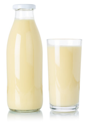 Banana smoothie fruit juice drink milkshake milk shake in a bottle and glass isolated on a white backgroundの写真素材