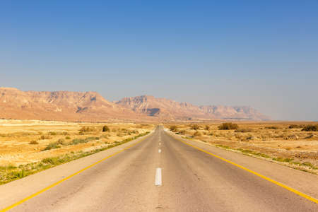 Endless road driving drive empty desert landscape copyspace copy space infinite distance travelの写真素材