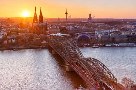Cologne Cathedral church Germany skyline city town sunset bridge eveningのeditorial素材