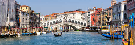 Venice Rialto bridge over Grand Canal with gondola travel traveling holidays vacation town city panorama in Italyの写真素材