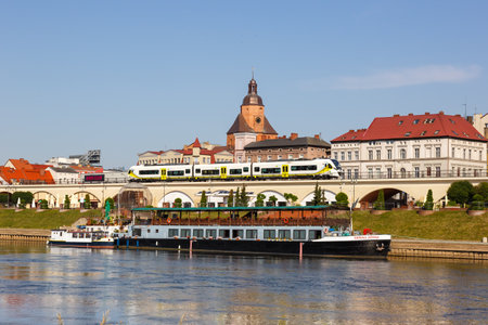 GorzÃ³w Wielkopolski, Poland - July 21, 2022: GorzÃ³w Wielkopolski town city at river Warta with a regional train type Newag Impuls 2 in Poland.のeditorial素材