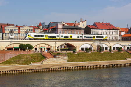 GorzÃ³w Wielkopolski, Poland - July 21, 2022: GorzÃ³w Wielkopolski town city at river Warta with a regional train type Newag Impuls 2 in Poland.のeditorial素材