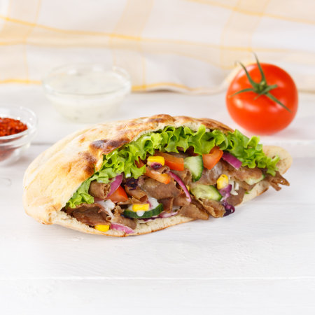 Doner Kebab Doner Kebab fast food in flatbread on a wooden board square snackの写真素材