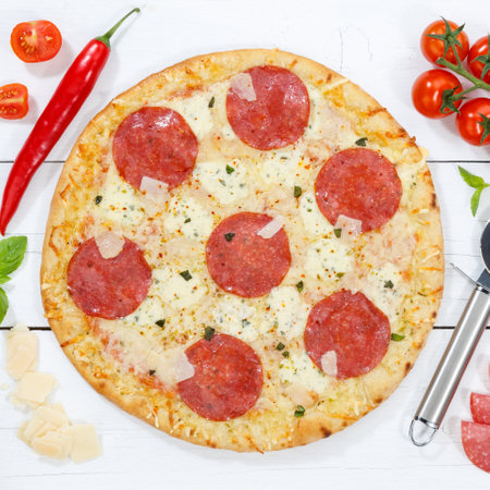 Salami pizza from above square ingredients on wooden board woodの写真素材